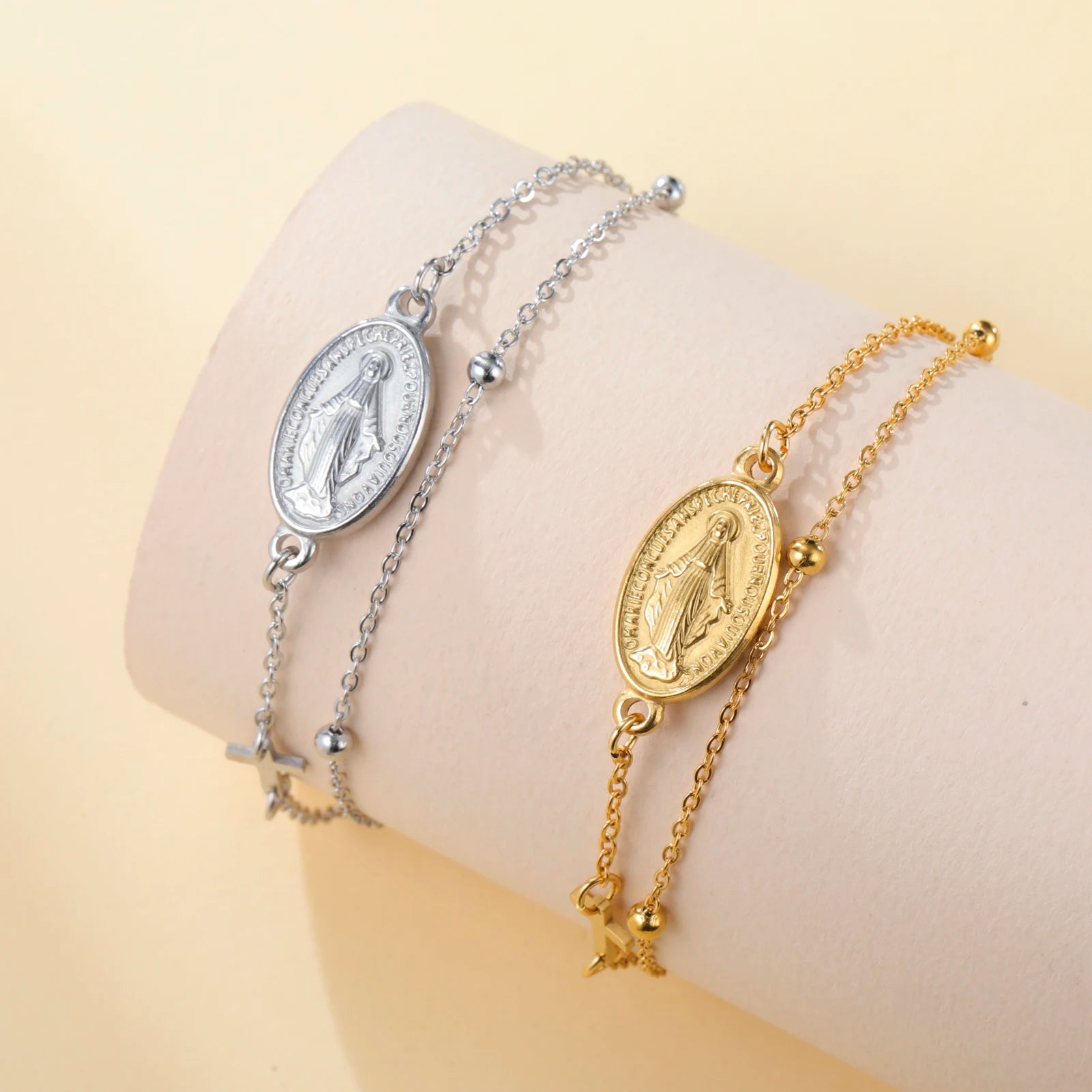 Stainless steel bracelet with oval Virgin Mary pendant, cross charm, and link chain