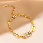 Gold chain geometric bracelet with curved bar links and rhinestone center panel