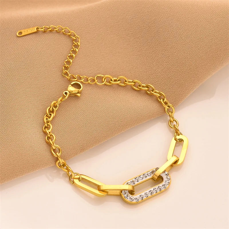 Gold chain geometric bracelet with curved bar links and rhinestone center panel