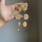 Tassel drop earrings, gold tone, four round woven discs connected by slender chains