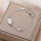 Stainless steel pendant bracelet with oval Virgin Mary medallion and cross charm links