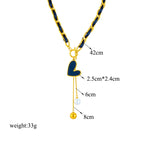 Gold-tone link necklace with black heart charm and hanging pearl and gold ball