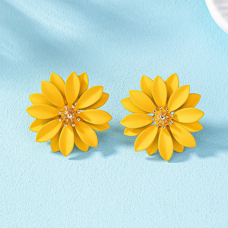 Yellow enamel flower stud earrings with gold-tone center and small crystal details.