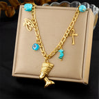 Gold-tone multi-pendant necklace with turquoise beads and cross, eye, bell charms