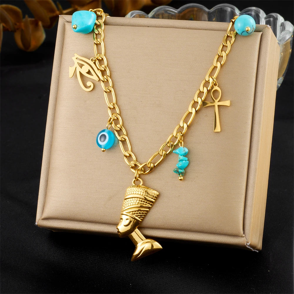 Gold-tone multi-pendant necklace with turquoise beads and cross, eye, bell charms