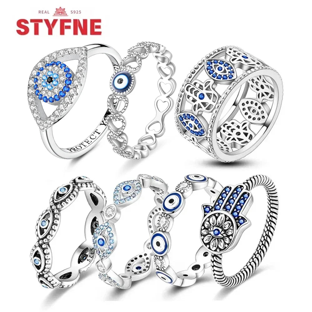 Sterling silver evil eye ring with blue circular center and crystal halo bezel