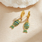 Fish enamel huggie hoop earrings, gold-tone with striped teal and blue fish charms