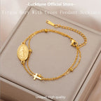 Gold-tone pendant bracelet with oval Virgin Mary medallion and a cross charm on chain