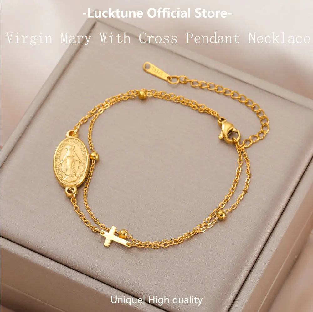 Gold-tone pendant bracelet with oval Virgin Mary medallion and a cross charm on chain