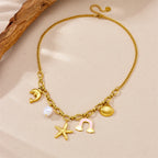 Gold-tone multi-pendant necklace with dolphin, pearl, rainbow cloud and starfish charms
