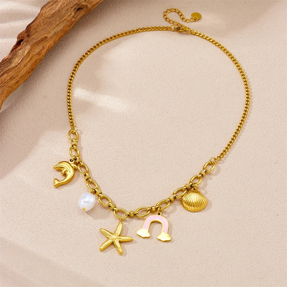 Gold-tone multi-pendant necklace with dolphin, pearl, rainbow cloud and starfish charms
