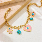 Gold-tone charm bracelet with evil eye heart, hamsa hand, and turquoise flower charm