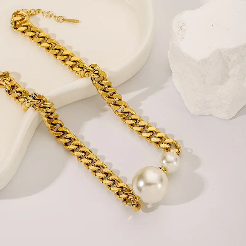 Gold-tone Cuban chain necklace with two round pearls and clasp at the end