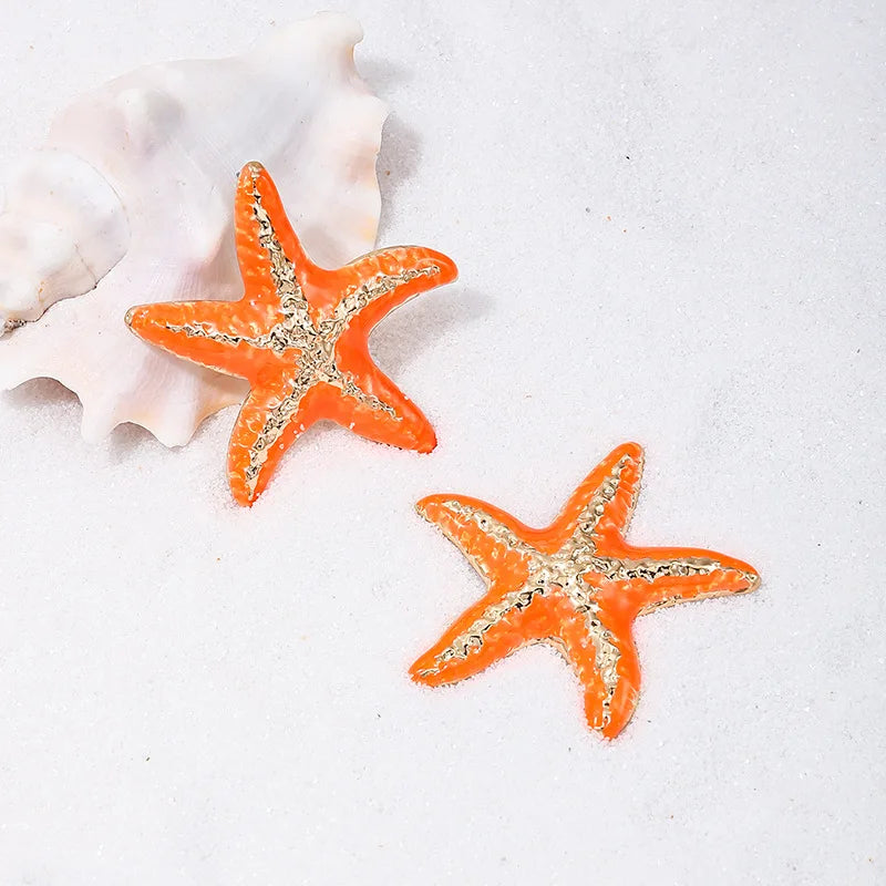 Starfish stud earrings, orange starfish with silver-tone textured center, pair