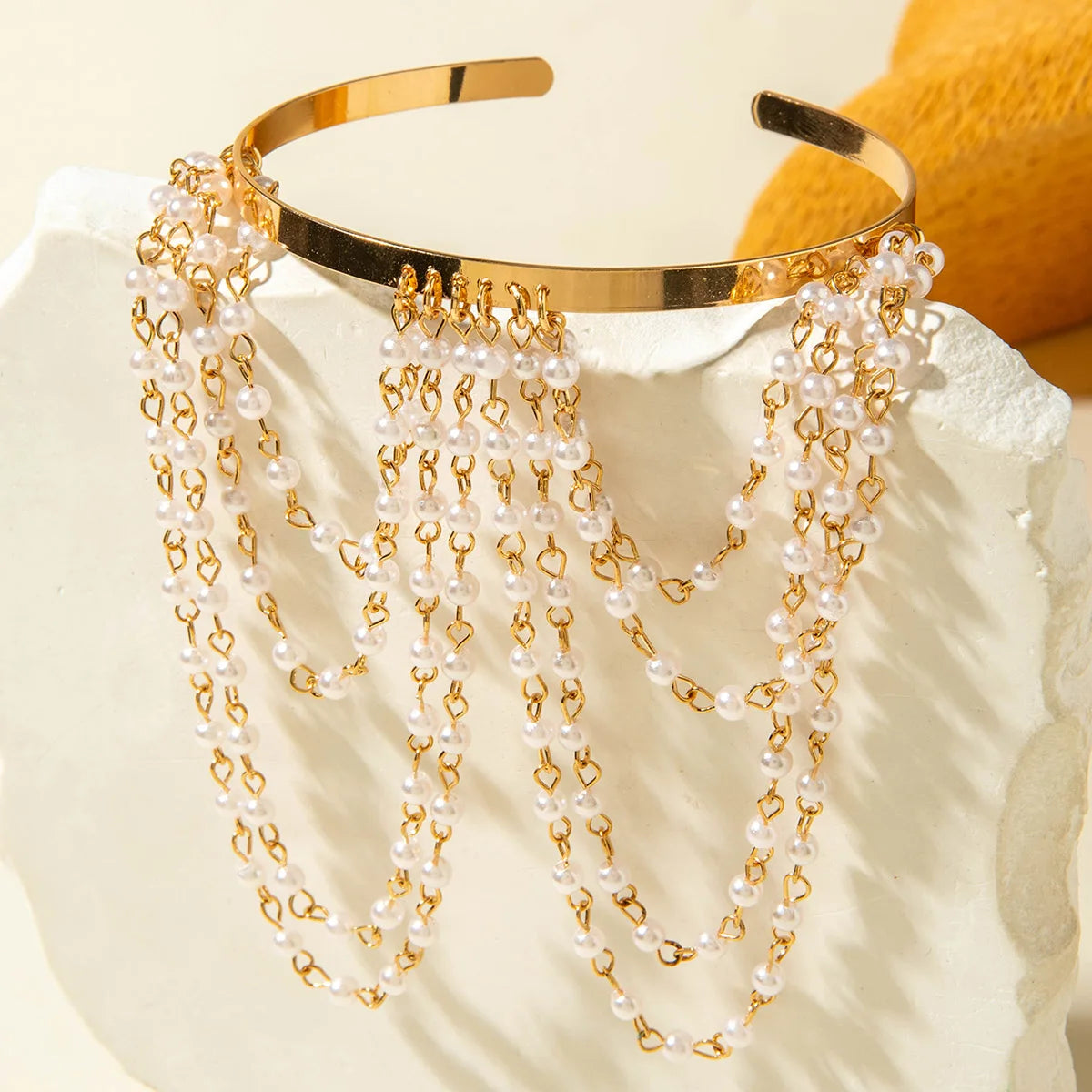Gold-tone upper arm bracelet with pearl fringe and small connector details