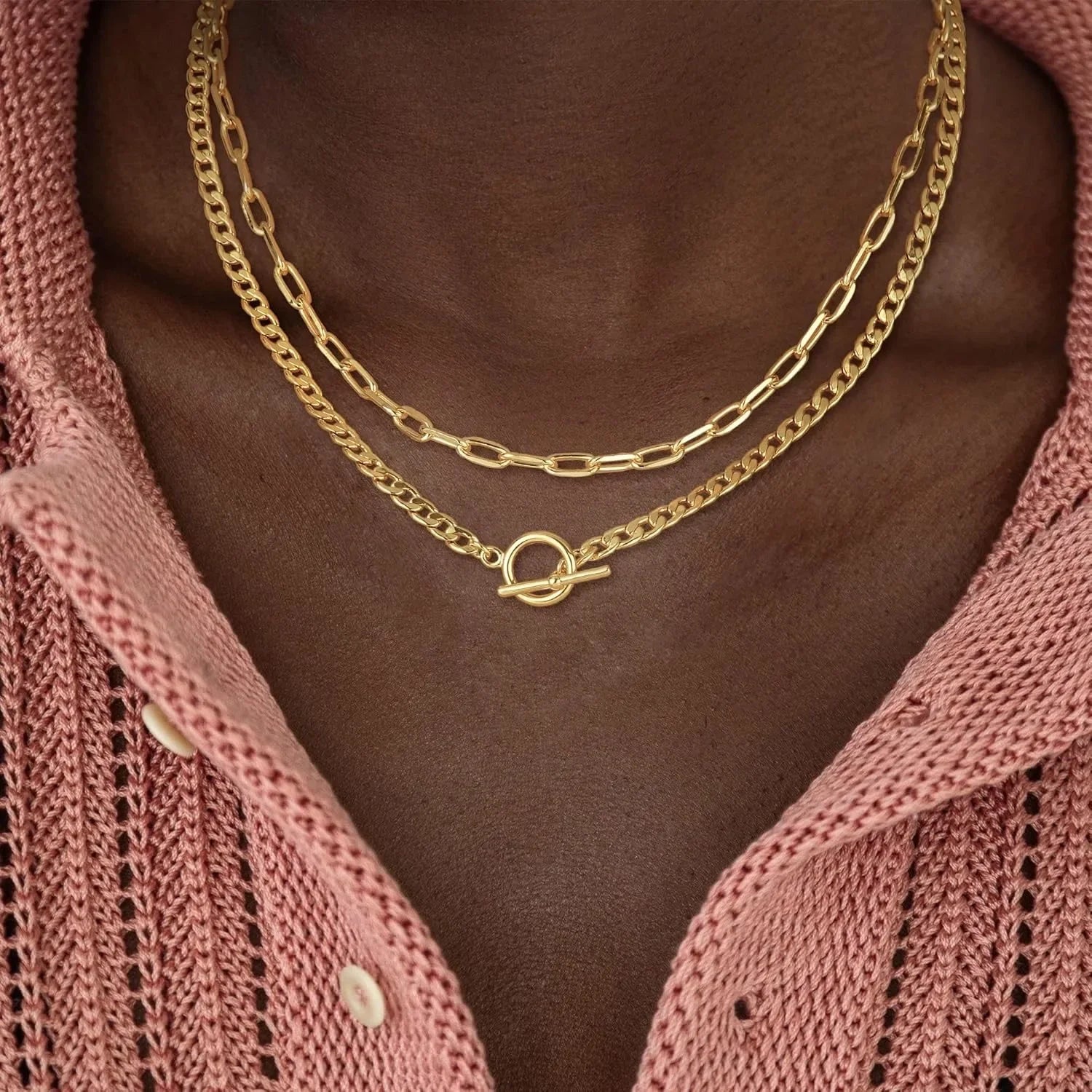 Gold layered chain necklace with oval connector; Cuban link and paperclip styles