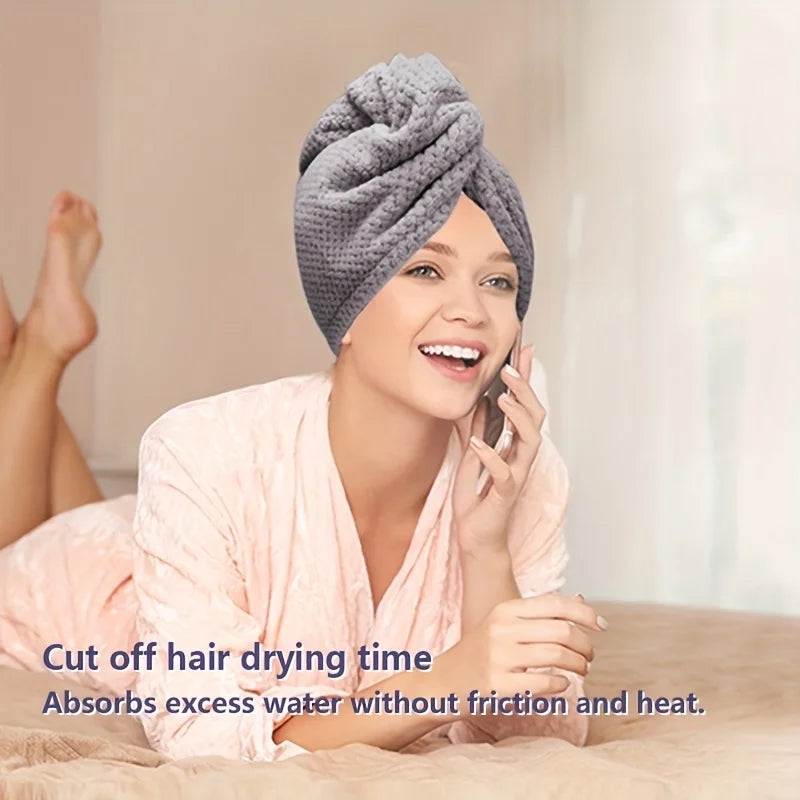 Pink absorbent hair towel wrap with double-button closure detail on the cuff