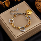 Two-tone curb chain bracelet with gold heart charm and heart-shaped links