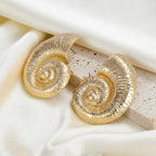 Gold-tone conch shell stud earrings with textured edges and spiral centers