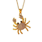 Rhinestone crab pendant necklace with gold-tone crab charm and sparkling stones