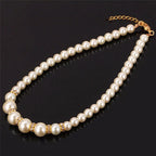 Pearl necklace with gold-tone crystal accents and a clasp chain
