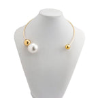 Gold-tone collar necklace with two white pearl beads and small gold end caps