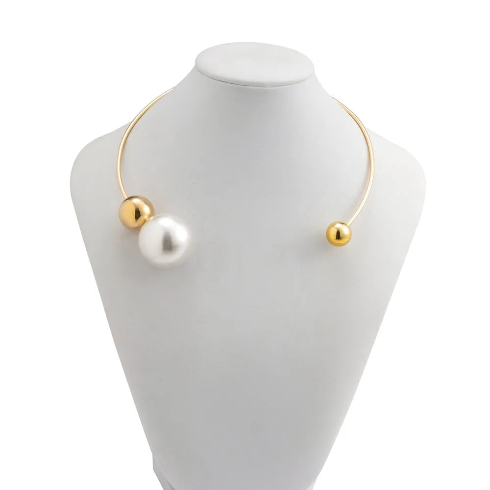 Gold-tone collar necklace with two white pearl beads and small gold end caps