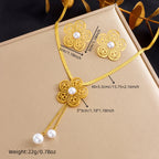Gold-tone flower necklace with white pearl drop and matching flower earrings