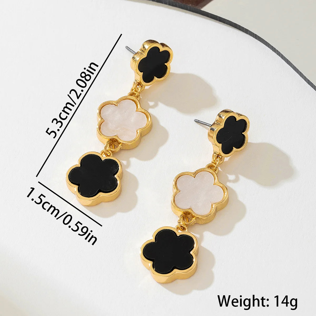 Five-petal flower long drop earrings, gold-tone with black and white enamel clover charms