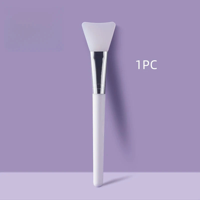 Face mask brush with white silicone head and chrome collar, white handle
