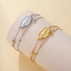 Silver- and gold-tone pendant bracelets with oval Virgin Mary medallions and cross charms