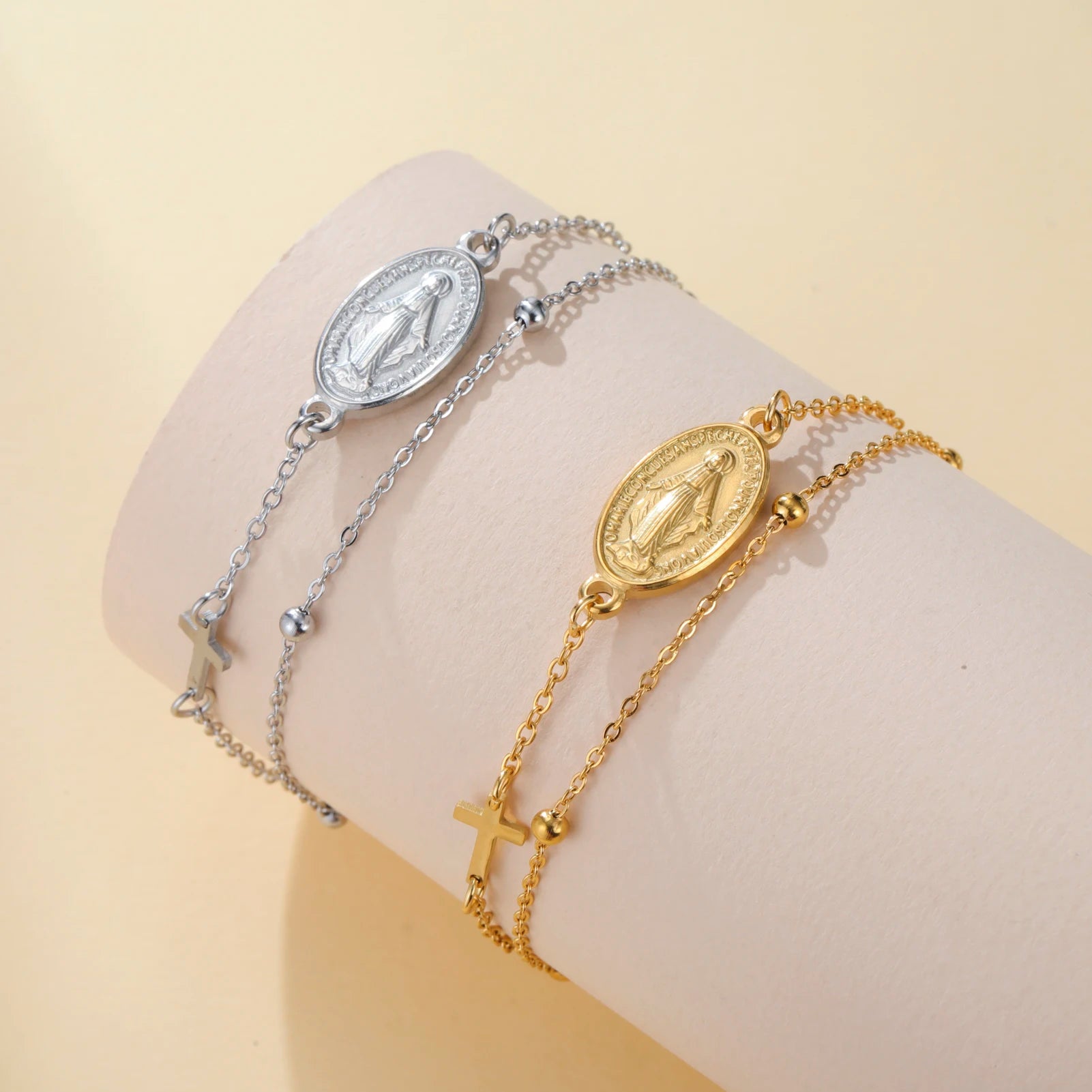 Silver- and gold-tone pendant bracelets with oval Virgin Mary medallions and cross charms