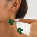 Floral stud earrings with layered green flower petals and gold-tone hooks