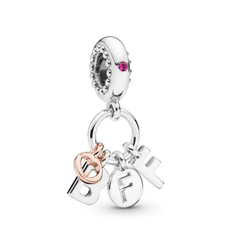 925 sterling silver charm with pink stone, hoop ring, and small letter charms