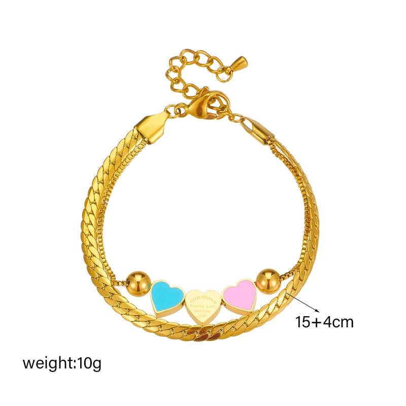 Gold heart charm bracelet with blue, pink, and white enamel heart pendants