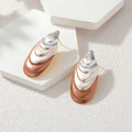 Two-tone flower stud earrings with layered teardrop petals in silver and rose