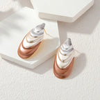 Two-tone flower stud earrings with layered teardrop petals in silver and rose