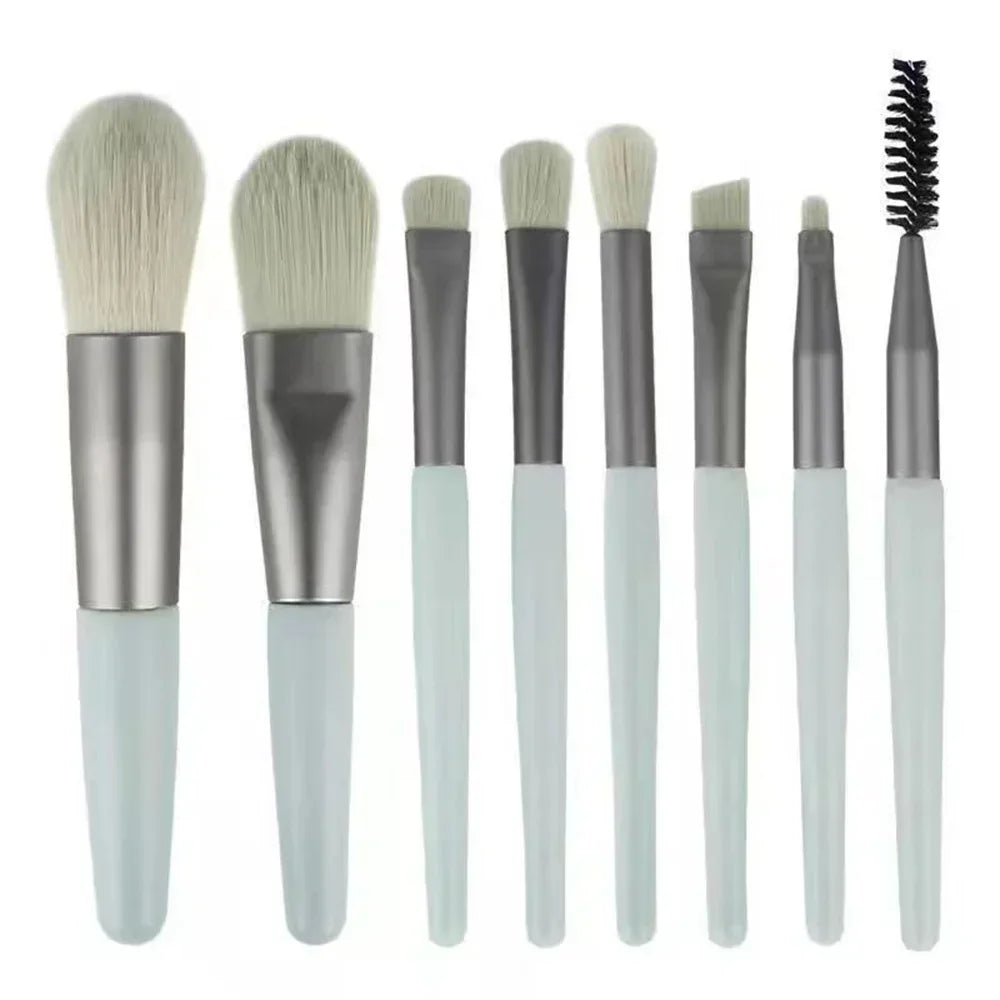 Makeup brush set with white handles and gray ferrules; includes black spoolie brush