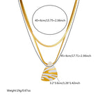Gold-tone layered necklace with white tiger stripe teardrop pendant