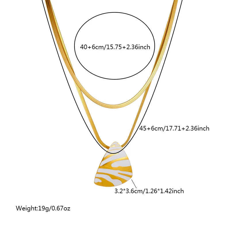 Gold-tone layered necklace with white tiger stripe teardrop pendant