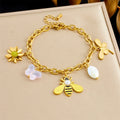 Gold-tone charm bracelet with bee, flower, and white petal/pearl accents
