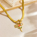 Gold-tone pendant necklace with rose charm and red enamel heart on snake chain
