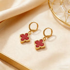 Four-leaf clover dangle earrings with red enamel clover charms and gold-tone hoops