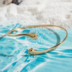 Gold-tone upper arm bracelet with smooth curved wire and small end studs