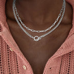 Layered silver-tone chain necklace with Cuban link and paperclip links, oval clasp detail
