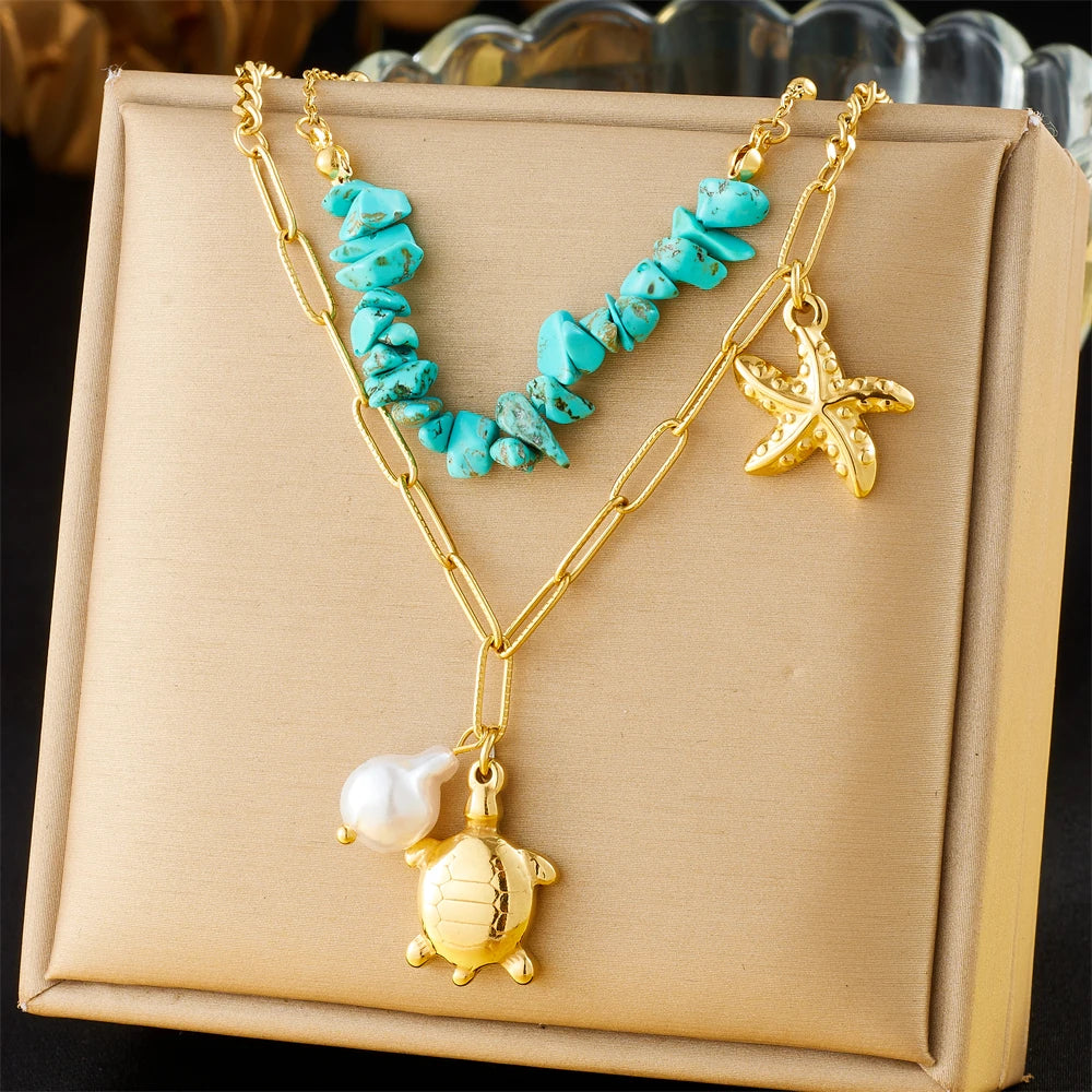 Turquoise beaded double-layer necklace with gold turtle, starfish, and pearl charms on pouch