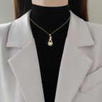 Gold-tone pearl drop pendant necklace with crystal accents