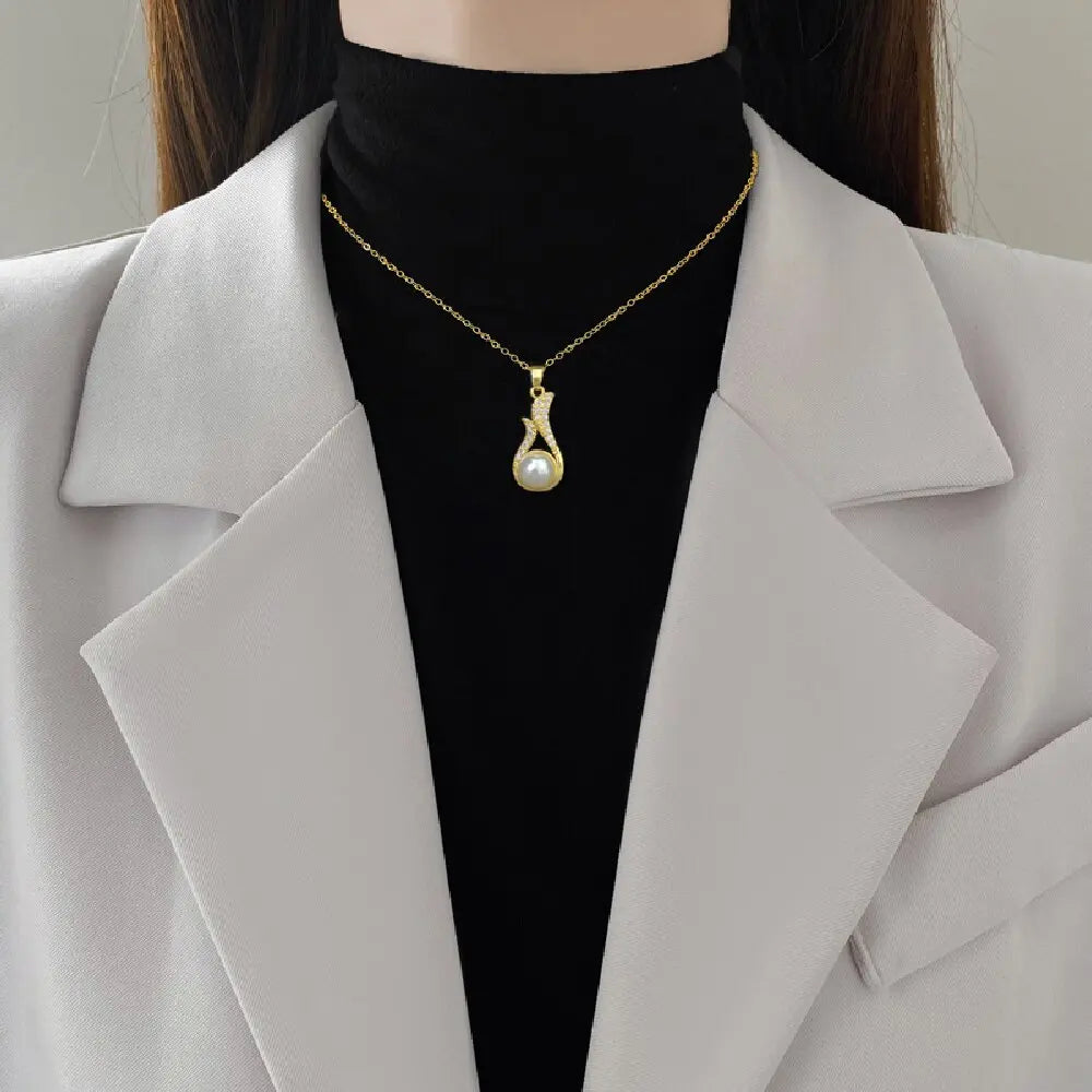 Gold-tone pearl drop pendant necklace with crystal accents