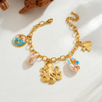 Gold-tone shell charm necklace with octopus pendant and blue enamel shell with fish drop.