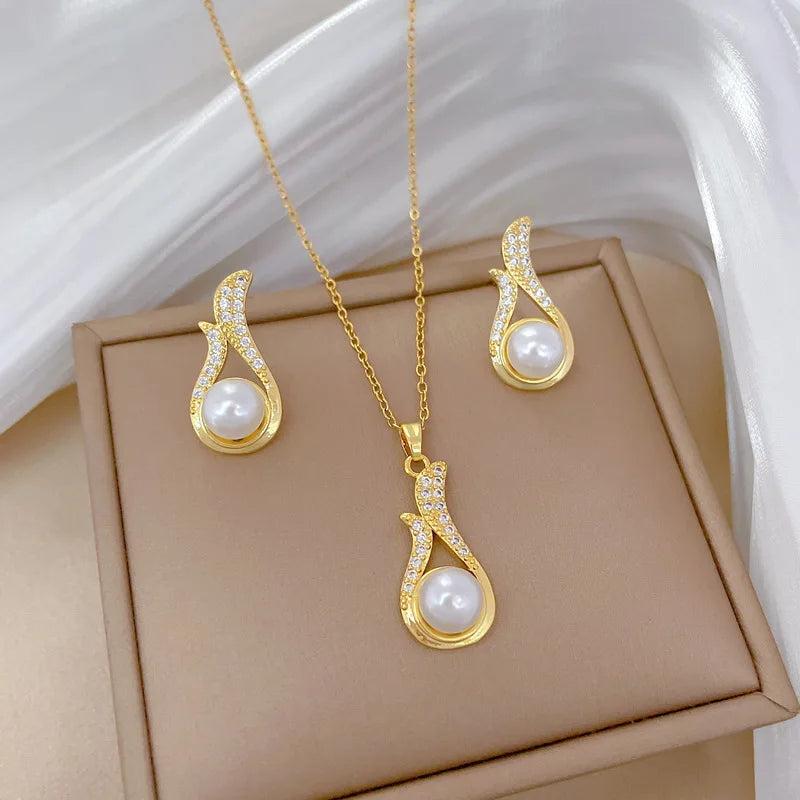 Gold-tone pearl drop pendant necklace with matching teardrop stud earrings